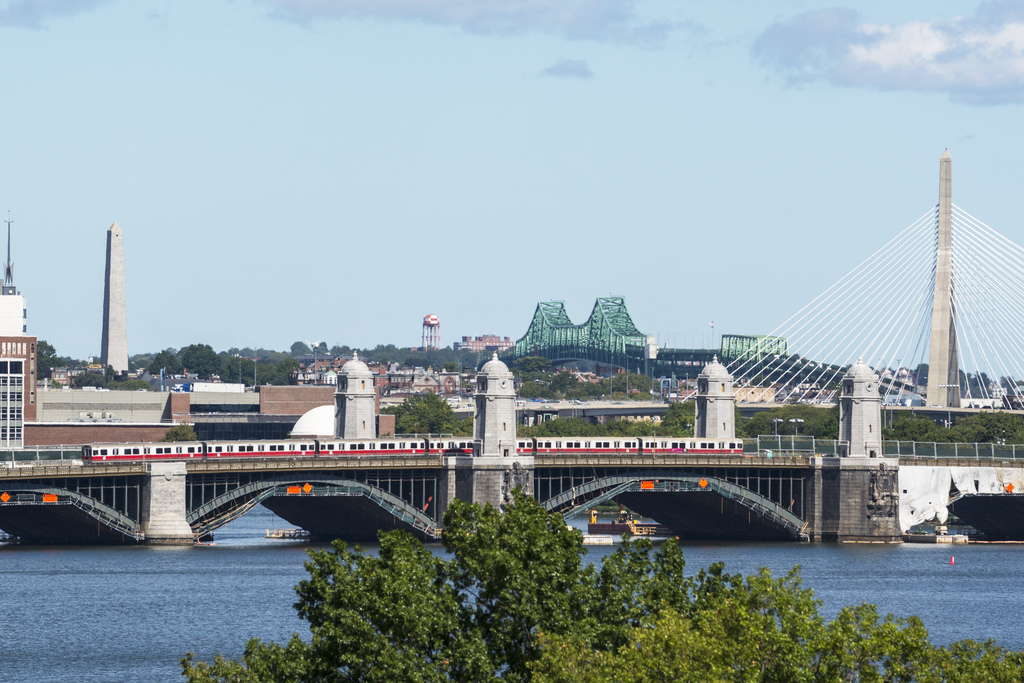 A Red Line train travels over the Longfellow Bridge, which crosses the Charles River.