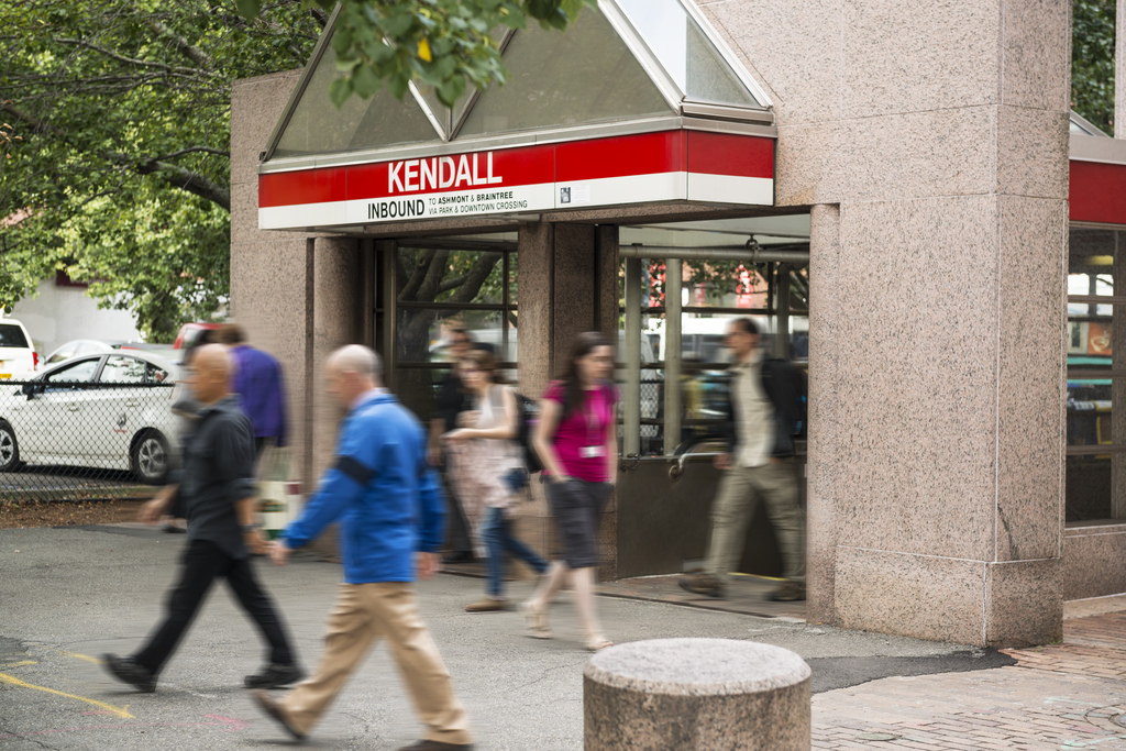 People walk past the entrance to the MIT Kendall T stop.