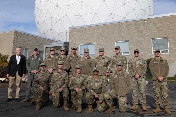 About 15 cadets in uniform pose for a photo