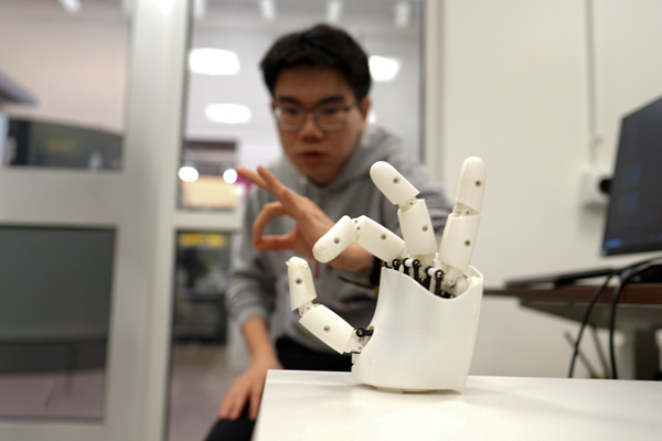 A researcher training a robotic hand